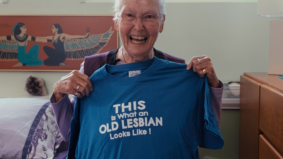 The image portrays the dignified and poignant lives of older lesbians, capturing moments of joy and depth.